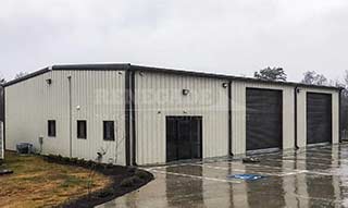 Renegade Steel Building: tan with brown trim and large roll up doors