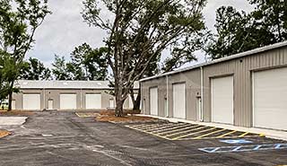 Renegade Steel Building: tan with white trim, large white roll updoors