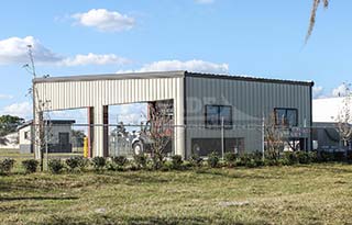 Tan Renegade Steel Building with brown trim and large openings