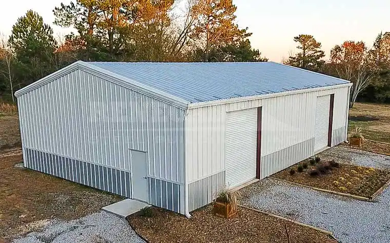 40x60 Renegade Steel Building with white walls, silver wainscot and large doors.