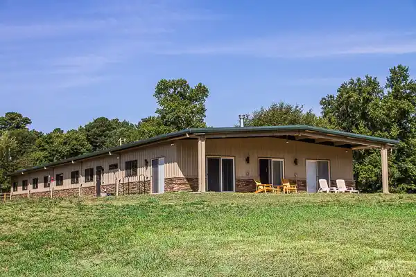 Renegade steel building barndominium with open bay porch