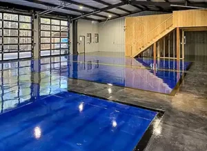 Shop interior with painted and polished concrete floor and large glass doors.