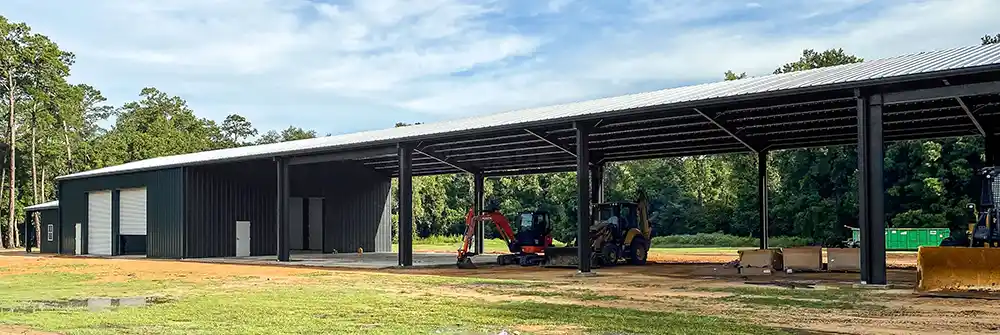Covered storage building with open bays and an enclosed portion.