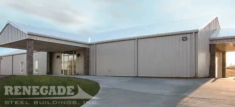 Gray steel building used for a church with drive under portico and entrance portico.
