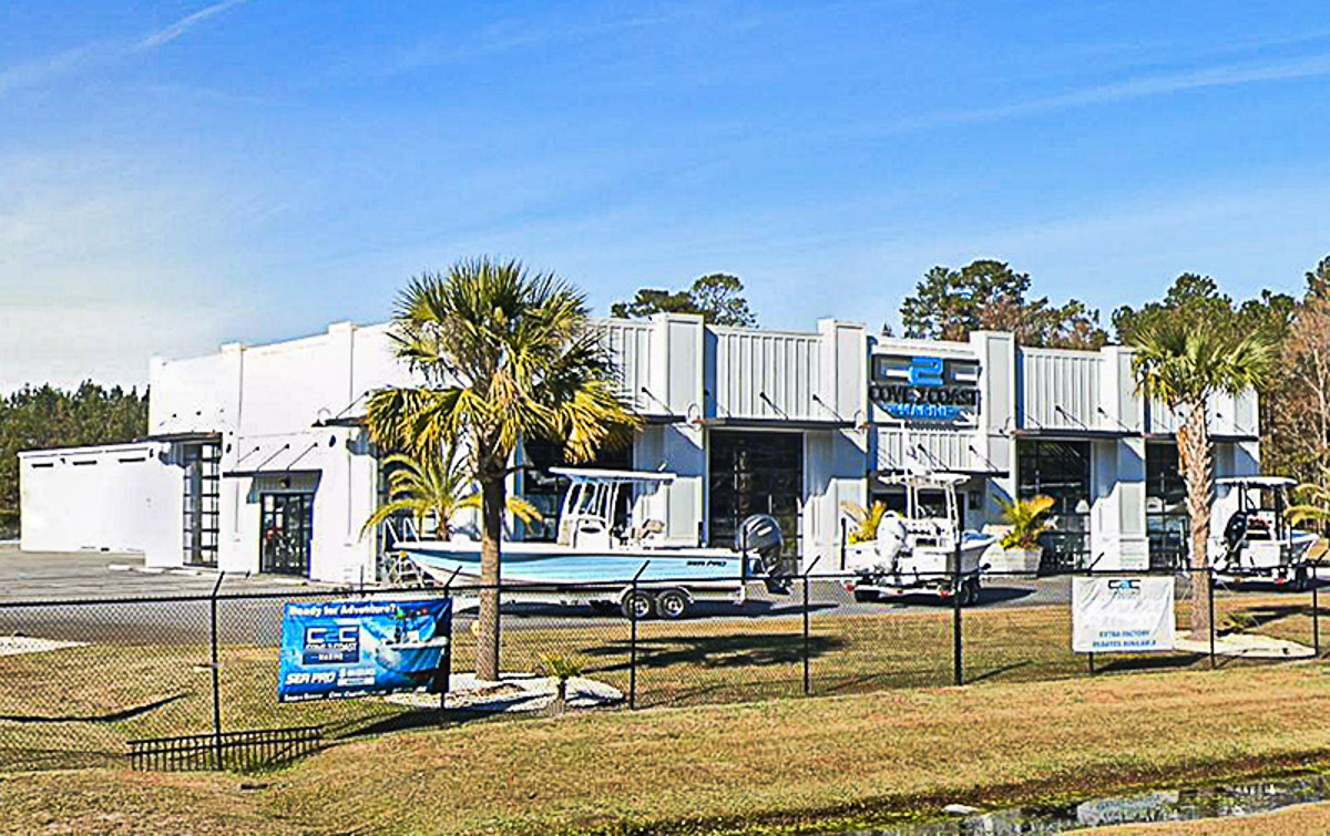 Two steel buildings serving as a boat dealership and a service garage.