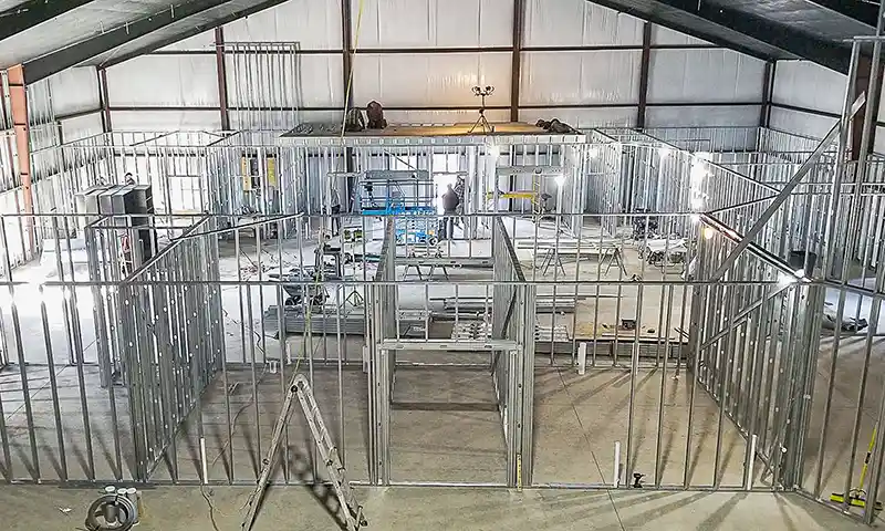 Interior framing with aluminum studs in a steel building
